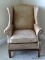 (BED 2) LEATHER UPHOLSTERED WING CHAIR WITH BRASS STUDDING AROUND THE ARMS. MEASURES 32 IN X 32 IN X