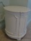 (BED 3) WHITE PAINTED ROUND END TABLE WITH BUN FEET. MEASURES 20 IN X 24 IN. ITEM IS SOLD AS IS