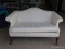 (GAR) SINGLE CUSHION CAMEL BACK SOFA WITH CARVED KNEES AND QUEEN ANNE LEGS. HAS A CREAM STRIPED