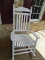 (FRNT PRCH) WHITE SLAT BOTTOM ROCKING CHAIR. MEASURES 26 IN X 34 IN X 48 IN. ITEM IS SOLD AS IS