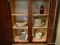 (BAS) CABINET LOT TO INCLUDE A SET OF TEMPTATIONS DINNERWARE WITH 6 BOWLS, 8 DINNER PLATES, AND 8