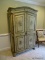 (DWN BED) ARMOIRE WITH FLORAL PAINTED EXTERIOR AND 2 DOORS THAT OPEN TO REVEAL A CLOSET ROD, AND 2