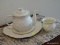 (FAM) BELLEEK LOT TO INCLUDE A TEAPOT AND UNDERPLATE, A VASE, AND A TEA CUP WITH UNDERPLATE. ITEM IS