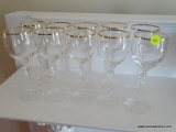 (FAM) SET OF 10 GOLD TONE RIMMED WHITE WINE STEMS WITH TWIST TURNED BASES. ITEM IS SOLD AS IS WHERE