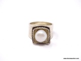 .925 STERLING SILVER FLOWER DESIGNED RING WITH HAMMERED SIDES & CENTER FAUX. PEARL. MARKED ON THE