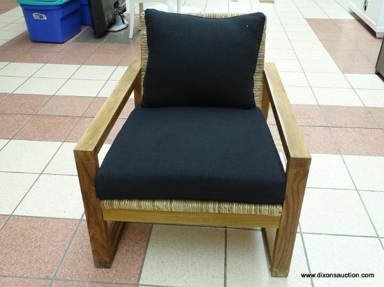 WOVEN SEAGRASS SEAT AND BACK ARM CHAIR WITH BLACK UPHOLSTERED CUSHION AND PILLOW. IS 1 OF A PAIR.