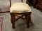 SOLID MAHOGANY AND GOLD TONE FABRIC UPHOLSTERED VANITY STOOL. MEASURES 16 IN X 16 IN X 19 IN. ITEM