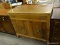 MAHOGANY 1 DRAWER OVER 2 DOOR STORAGE CABINET WITH BRASS OBLONG HANDLES. MEASURES 38 IN X 17.5 IN X