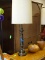 BRASS TABLE LAMP WITH REEDED BODY AND CYLINDRICAL SHADE. MEASURES 39.5 IN TALL. ITEM IS SOLD AS IS