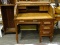 ANTIQUE OAK TG SELLEW C-ROLL DESK WITH INTERIOR DRAWERS AND STORAGE AS WELL AS 3 LOWER DRAWERS.
