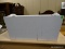 WHITE PAINTED DOUBLE HANDLED STORAGE BIN. MEASURES 22 IN X 14 IN X 11.5 IN. ITEM IS SOLD AS IS WHERE