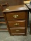 MAHOGANY 3 DRAWER NIGHTSTAND WITH BRASS PULLS AND BRACKET FEET. MEASURES 18.5 IN X 17.5 IN X 29 IN.