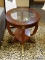 OVAL MAHOGANY END TABLE WITH CUT GLASS CENTER, BANDED TOP, REEDED LEGS WITH BRASS ACCENTS, AND A