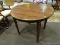 ROUND WOOD FINISH DINETTE TABLE WITH HEPPLEWHITE STYLE LEGS. MEASURES APPROXIMATELY 40 IN X 29 IN.