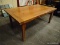 PINE DINING TABLE WITH SLIDE-OUT LEAVES AND PEGGED CONSTRUCTION. MEASURES 72 IN X 42 IN X 30 IN.