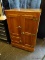 ANTIQUE OAK ICE BOX WITH BRASS HARDWARE AND PORCELAIN INTERIOR. HAS A TOTAL OF 3 SEPERATE DOORS THAT