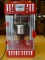 ELITE POPCORN BRAND POPCORN MAKER IN RED AND SILVER. MEASURES 9 IN X 9 IN X 19 IN. ITEM IS SOLD AS