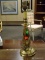BRASS CANDLESTICK STYLE LAMP. NEEDS HARP AND FINIAL. MEASURES 16 IN TALL. ITEM IS SOLD AS IS WHERE