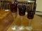 LOT OF 3 RED AND CLEAR DECORATIVE STEM GLASSES. TALLEST MEASURES 16 IN TALL. ITEM IS SOLD AS IS