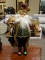 SANTA FIGURINE OF AN OLD WORLD STYLE SANTA HOLDING A LUTE AND A FRENCH HORN. MEASURES 19 IN TALL.