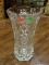 PRESSED GLASS VASE WITH A FLORAL PATTERN. MEASURES 10.5 IN TALL. ITEM IS SOLD AS IS WHERE IS WITH NO