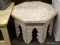 OCTAGONAL MIDDLE-EASTERN STYLE END TABLE IN OFF-WHITE AND BROWN WITH A FLORAL AND LEAF PATTERN.
