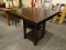 ESPRESSO FINISH DINING TABLE WITH A SQUARE BASE AND 2 LOWER SHELVES. MEASURES APPROXIMATELY 40 IN X