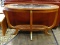 OVAL MAHOGANY CONSOLE TABLE WITH CUT GLASS CENTER, BANDED TOP, REEDED LEGS WITH BRASS ACCENTS, AND A