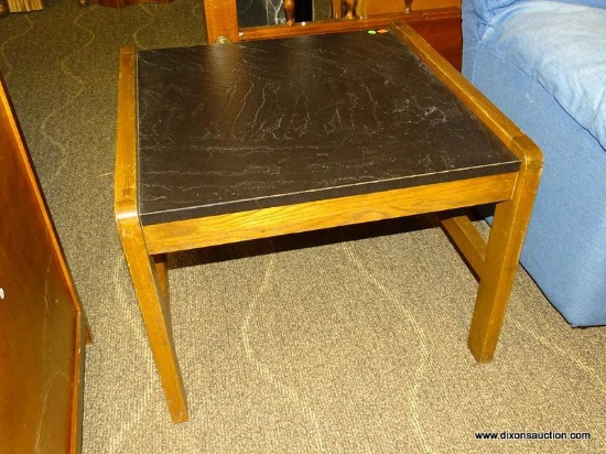 OAK AND BLACK FORMICA TOP END TABLE WITH STRETCHER BASE. MEASURES 27 IN X 28 IN X 21 IN. ITEM IS