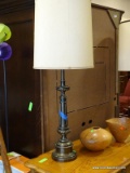 BRASS TABLE LAMP WITH REEDED BODY AND CYLINDRICAL SHADE. MEASURES 39.5 IN TALL. ITEM IS SOLD AS IS