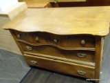 ANTIQUE OAK 4 DRAWER DRESSER WITH SERPENTINE FRONT AND BRASS PULLS. MEASURES 45 IN X 22 IN X 30 IN.
