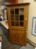 VINTAGE 2 PIECE OAK CORNER CABINET WITH CROWN MOLDING, 9 PANELED AREAS ON THE DOOR (7 HAVE GLASS
