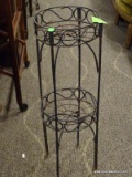 2 TIER IRON PLANT STAND WITH SWIRLING DETAILS. MEASURES 10 IN X 28 IN. ITEM IS SOLD AS IS WHERE IS