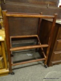 FOLDING MAHOGANY STAND. POSSIBLY A VALET STAND. HAS WHEELS ON THE FEET FOR EASY MOVEMENT. MEASURES