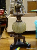 MODERN TABLE LAMP WITH A GLASS MELON STYLE BODY AND BRONZE AND BLACK ACCENTS. MEASURES 24 IN TALL.