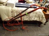 ANTIQUE WHEEL PLOW WITH WOODEN HANDLES. MEASURES 24 IN X 20 IN X 45 IN. ITEM IS SOLD AS IS WHERE IS