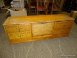 SOLID OAK 4 DRAWER AND ROLL TOP DOOR ORGANIZER WITH DIVIDED INTERIORS IN THE DRAWERS. MEASURES 55 IN