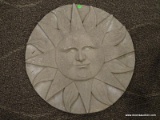 ROUND CONCRETE WALL HANGER WITH A SUN WITH A FACE MADE INTO THE FRONT. MEASURES 25