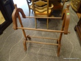 MAHOGANY QUILT RACK WITH 2 ARMS FOR HANGING QUILTS. MEASURES 28 IN X 16 IN X 35.5 IN. ITEM IS SOLD