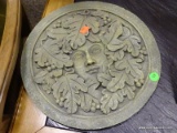 ROUND PLASTER WALL HANGING GARDEN DECORATION OF A WOMAN'S FACE SURROUNDED BY LEAVES. IS GREEN IN