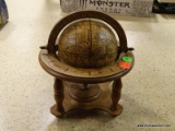 MINIATURE GLOBE ON STAND. IS BROWN IN COLOR AND MEASURES 8 IN X 9 IN. ITEM IS SOLD AS IS WHERE IS