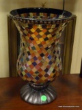 MOSAIC TILE VASE WITH BROWN BASE AND AN ORANGE CANDLE. MEASURES 8 IN X 12.5 IN. ITEM IS SOLD AS IS