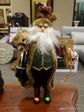 SANTA FIGURINE OF AN OLD WORLD STYLE SANTA HOLDING A LUTE AND A FRENCH HORN. MEASURES 19 IN TALL.