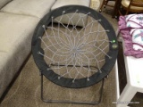 BLACK BUNJO BUNGEE STYLE CHAIR. FOLDS FOR EASY STORAGE. MEASURES 31.5 IN X 32 IN. ITEM IS SOLD AS IS