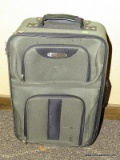 GREEN AND BLACK UPHOLSTERED SUITCASE WITH SILVER TONED ZIPPER HANDLES AND A TELESCOPING HANDLE FOR