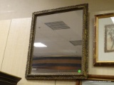 VINTAGE GOLD TONE FRAMED MIRROR. MEASURES 22 IN X 29 IN. HAS SOME OF THE FRAME CHIPPED NEAR THE TOP.