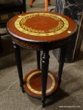 MAHOGANY END TABLE WITH REEDED COLUMN LEGS AND 1 LOWER SHELF. HAS AN OLIVE BRANCH THEMED TOP.