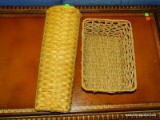 LOT OF 2 WOVEN BASKETS. 1 IS ELONGATED WITH A HANDLE AND 1 IS A WOVEN ROPED STYLE BASKET. ITEM IS