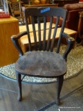ANTIQUE OAK ARM CHAIR WITH SLAT BACK AND PLANK BOTTOM SEAT. MEASURES 26 IN X 19 IN X 37.5 IN. ITEM