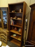 OAK SHELVING UNIT WITH ADJUSTABLE SHELVING HEIGHTS. MEASURES 30 IN X 12.5 IN X 82.5 IN. ITEM IS SOLD